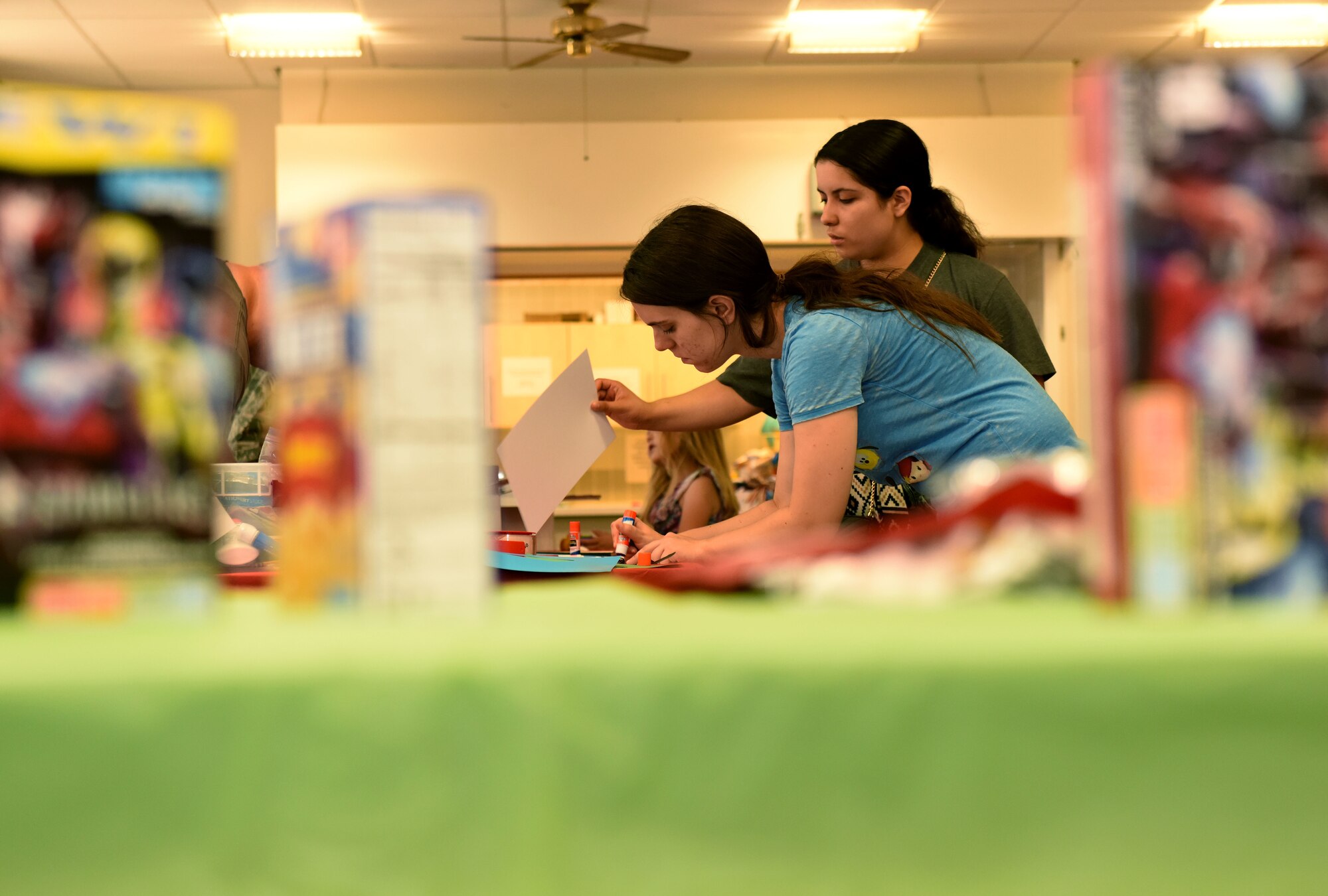 Team Mildenhall children decorate care packages for deployed parents and friends at RAF Mildenhall, England, July 24, 2018. The care packages are decorated and filled with donated snacks and messages from family and friends. (US. Air Force photo by Senior Airman Lexie West)