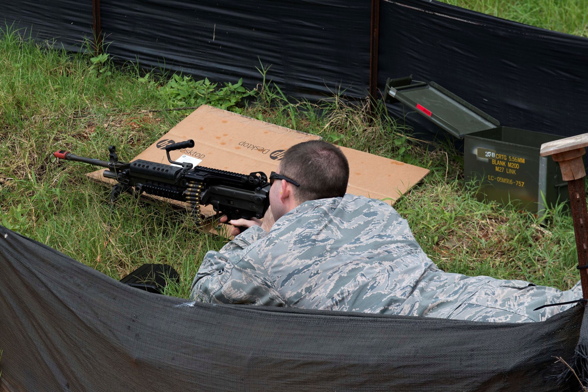 A U.S. Airman shoots blanks from an M-240 machine gun during an exercise put on by the 20th Medical Group (MDG) at Shaw Air Force Base, S.C., Aug. 2, 2018.