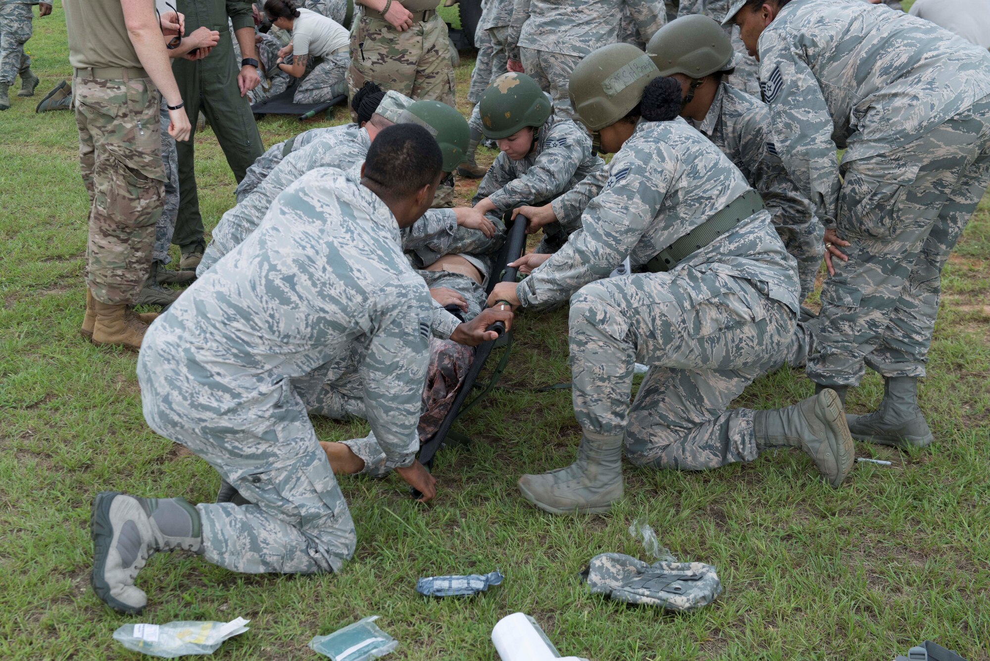 U.S. Airmen assigned to the 20th Medical Group place a simulated patient on a litter during an exercise at Shaw Air Force Base, S.C., Aug. 2, 2018.