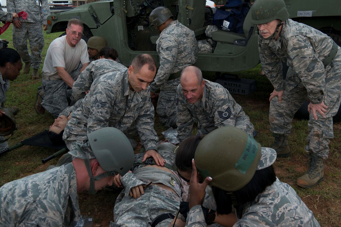 U.S. Airmen assigned to the 20th Medical Group strap a simulated patient to a litter during an exercise at Shaw Air Force Base, S.C., Aug. 2, 2018.
