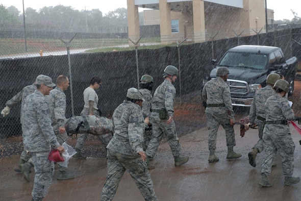 U.S. Airmen assigned to the 20th Medical Group carry simulated patients and equipment during an exercise at Shaw Air Force Base, S.C., Aug. 2, 2018.