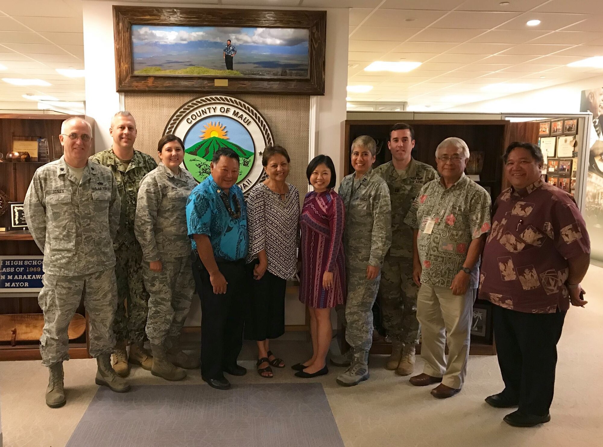 Maui County Mayor Alan Arakawa, fourth from left, stands with military leaders and Maui County officials in June 2018 to plan Tropic Care Maui County 2018. About 350 Guard, Reserve, and active duty military members arrived in Maui, Molokai, and Lanai to set up no-cost healthcare clinics as part of the U.S. military Innovative Readiness Training initiative. 
Military members will provide medical, vision, and dental services at sites in Central Maui, Kihei, Lahaina, Hana, Molokai, and Lanai, August 11-19. The training mission is led by the Air National Guard and supported by members of the Air Force, Army, Navy Reserve, and Marine Corps Reserve. 
Maui County and the Hawaii State Department of Health are partnering with the military for this mission, working closely with community members to organize the clinics. (Courtesy photo)