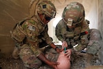 Army Spc. Nicholas Leveretter, left, and Pfc. Lani Suther administer a nasal pharyngeal tube to a mock casualty while practicing combat lifesaver techniques at Bagram Air Field, Afghanistan, July 26, 2018. Army photo by 1st Lt. Verniccia Ford