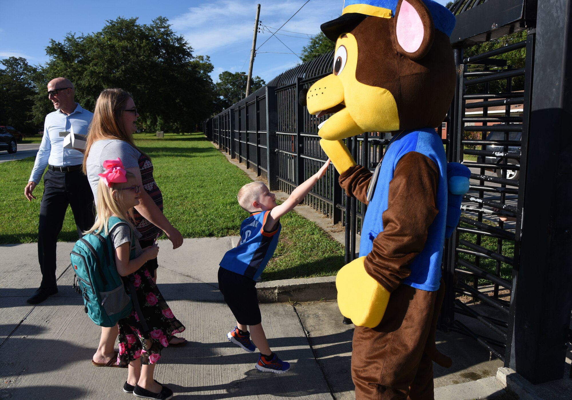 Carson Hunt, son of Tech. Sgt. John Hunt, 333rd Training Squadron instructor, gives a high-five to Chase the Paw Patrol dog on Keesler Air Force Base, Mississippi, Aug. 6, 2018. Keesler children were greeted by members from the 81st Security Forces Squadron, Keesler Fire Department and 81st Force Support Squadron as they went Jeff Davis Elementary School on the first day of school. (U.S. Air Force photo by Kemberly Groue)