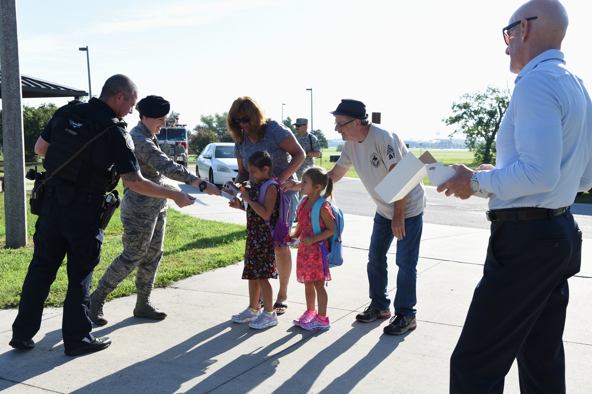 Keesler personnel hand out stickers to Keesler children on Keesler Air Force Base, Mississippi, Aug. 6, 2018. Keesler children were greeted by members from the 81st Security Forces Squadron, Keesler Fire Department and 81st Force Support Squadron as they went to Jeff Davis Elementary School on the first day of school. (U.S. Air Force photo by Kemberly Groue)