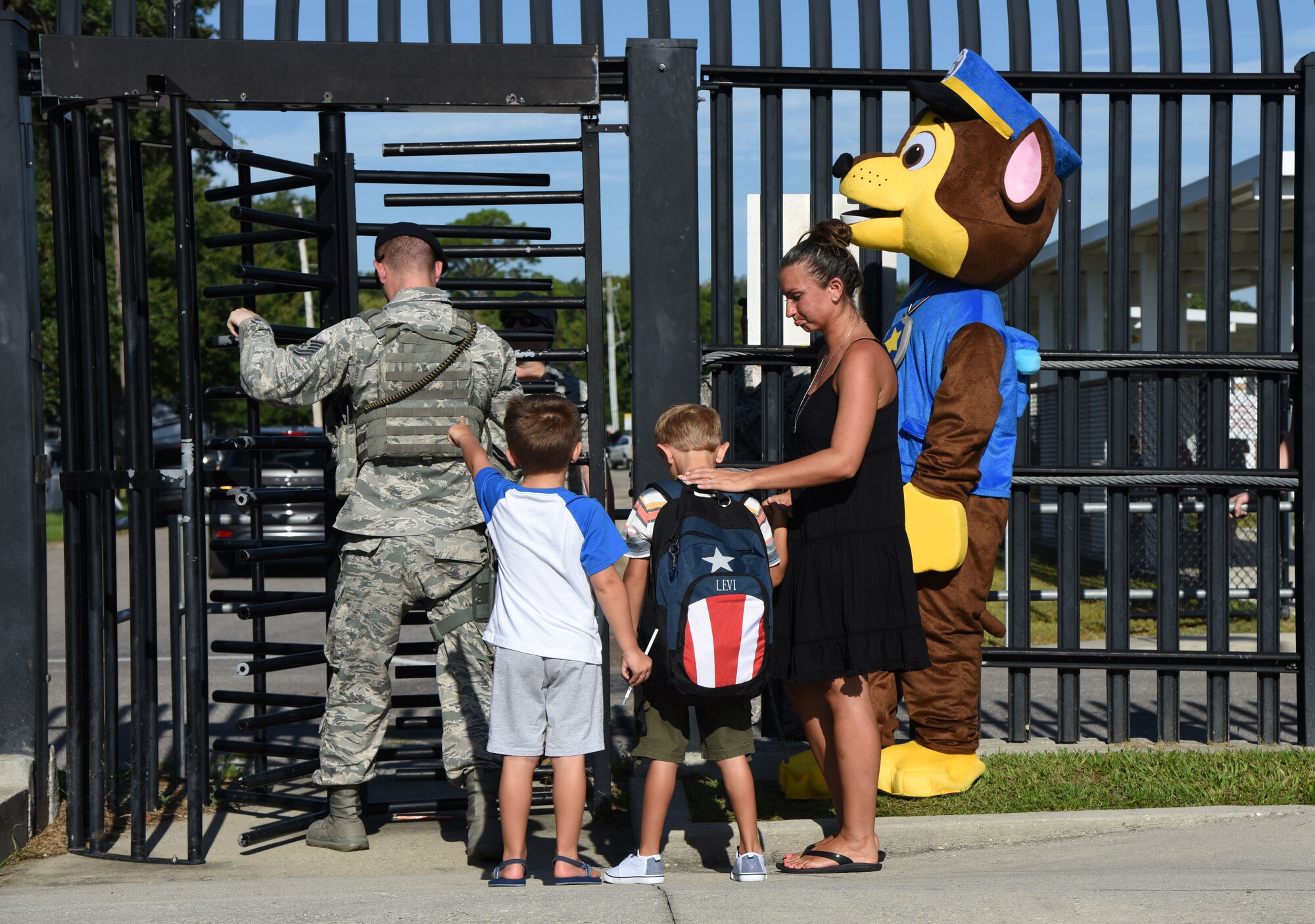 Julia, Levi and Brody, sons of 2nd Lt. Steven Ryan, 81st Medical Group medical administrator, prepare to cross the Jeff Davis Elementary School security gate on Keesler Air Force Base, Mississippi, Aug. 6, 2018. Keesler children were greeted by members from the 81st Security Forces Squadron, Keesler Fire Department and 81st Force Support Squadron as they went to their first day of school. (U.S. Air Force photo by Kemberly Groue)