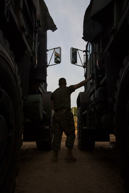 A Marine with Truck Company, Headquarters Battalion, out of Erie, Pa., inspects the cab of a 7-ton truck at Camp Grayling, Mich., in support of Exercise Northern Strike, Aug. 5, 2018.