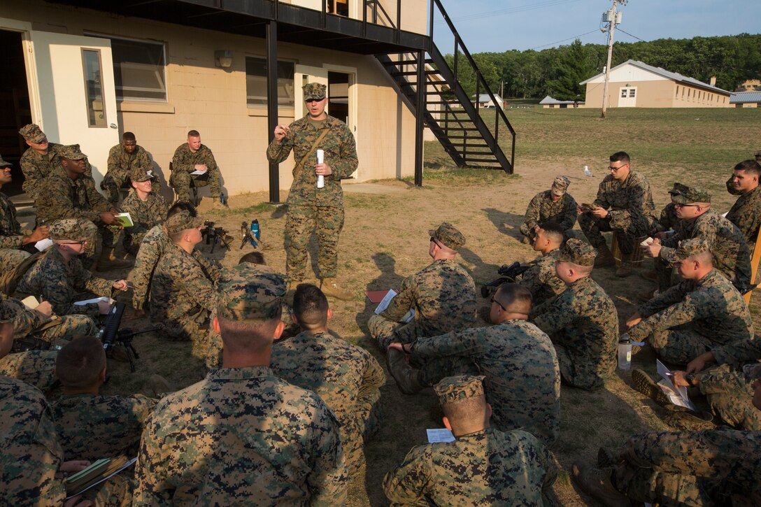 Marines from 3rd Battalion, 25th Marine Regiment, listen to a class on proficiency and conduct marks during a period of down time at Camp Grayling, Mich., at Exercise Northern Strike, Aug. 5, 2018.