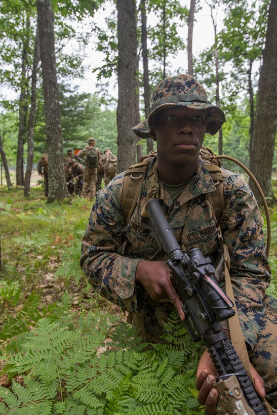 U.S. Marine Corps Lance Cpl. Jahmel Bluntholley, a rifleman with Kilo Company, 3rd Battalion, 25th Marine Regiment, posts security while his fire team checks a target point during a land navigation course at Exercise Northern Strike in Camp Grayling, Mich., Aug. 6, 2018.