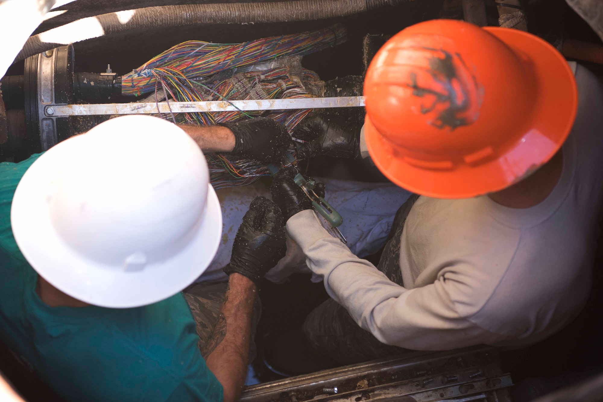 30th Space Communication Squadron Airmen work on splicing wires July 18, 2018, on Vandenberg Air Force Base, Calif. The Airmen are responsible for making sure that power gets to the different buildings on base.