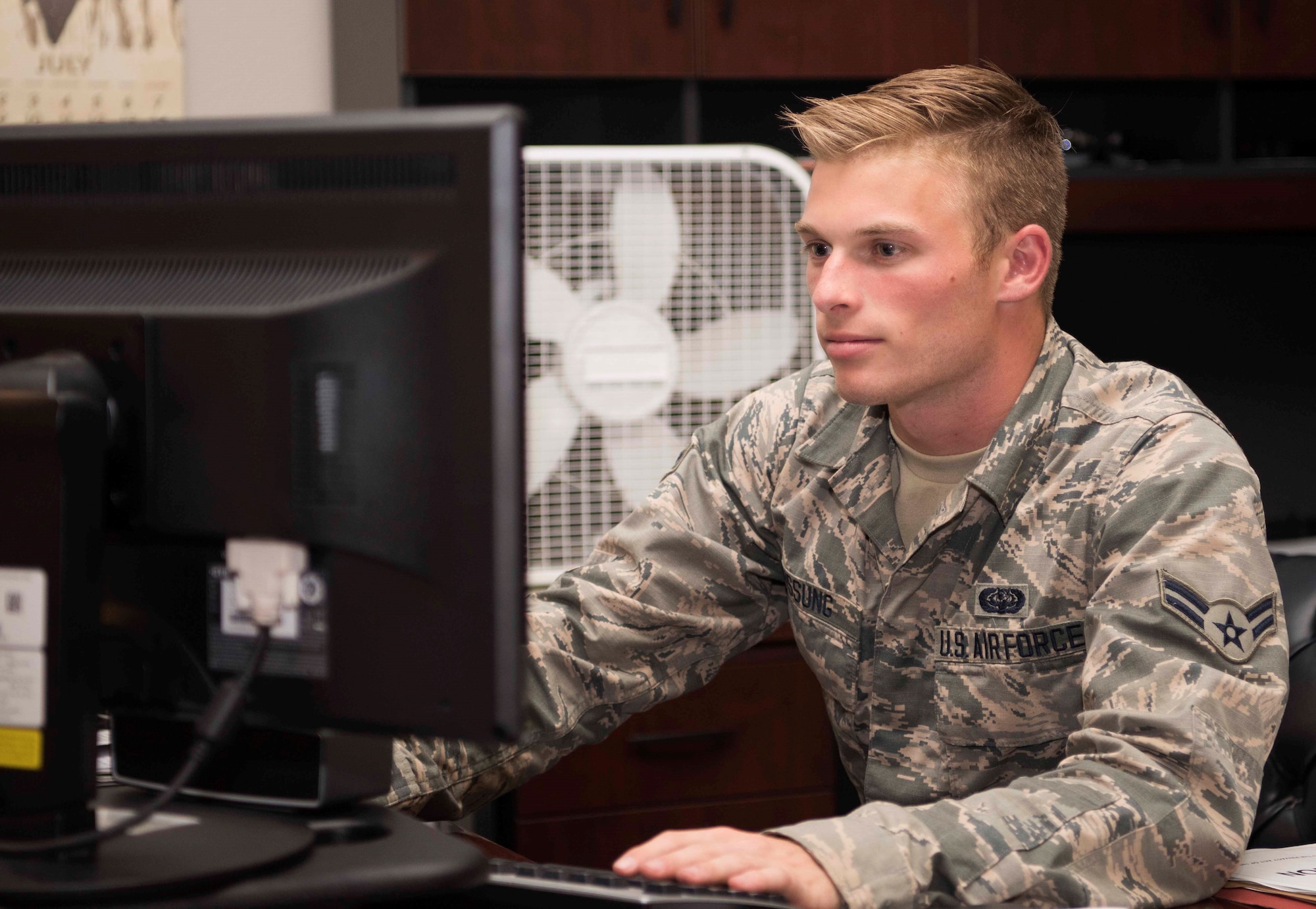 Airman 1st Class Ryan Hussung, 30th Space Communication Squadron Airman, works on a computer July 18, 2018, on Vandenberg Air Force Base, Calif. Hussung works for the knowledge management center in the squadron.