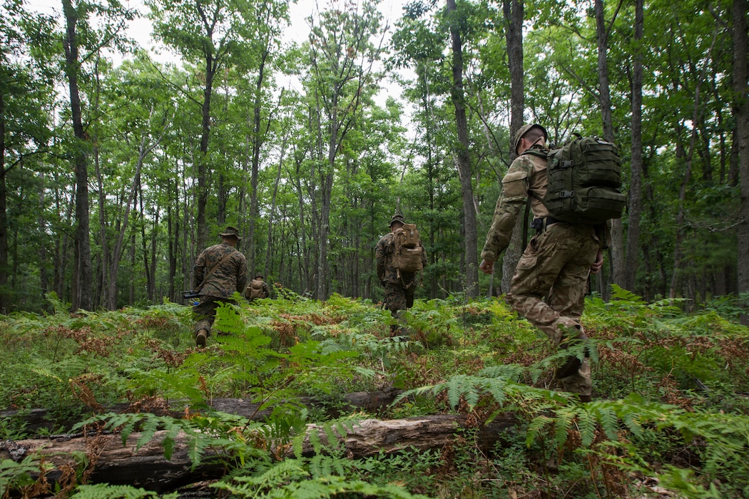 British Lance Cpl. PJ Moleod (left), a medic with 3rd Princess of Wales Royal Regiment and U.S. Marines from Kilo Company, 3rd Battalion, 25th Marine Regiment, hike towards a target point during a land navigation course at Exercise Northern Strike in Camp Grayling, Mich., Aug. 6, 2018.