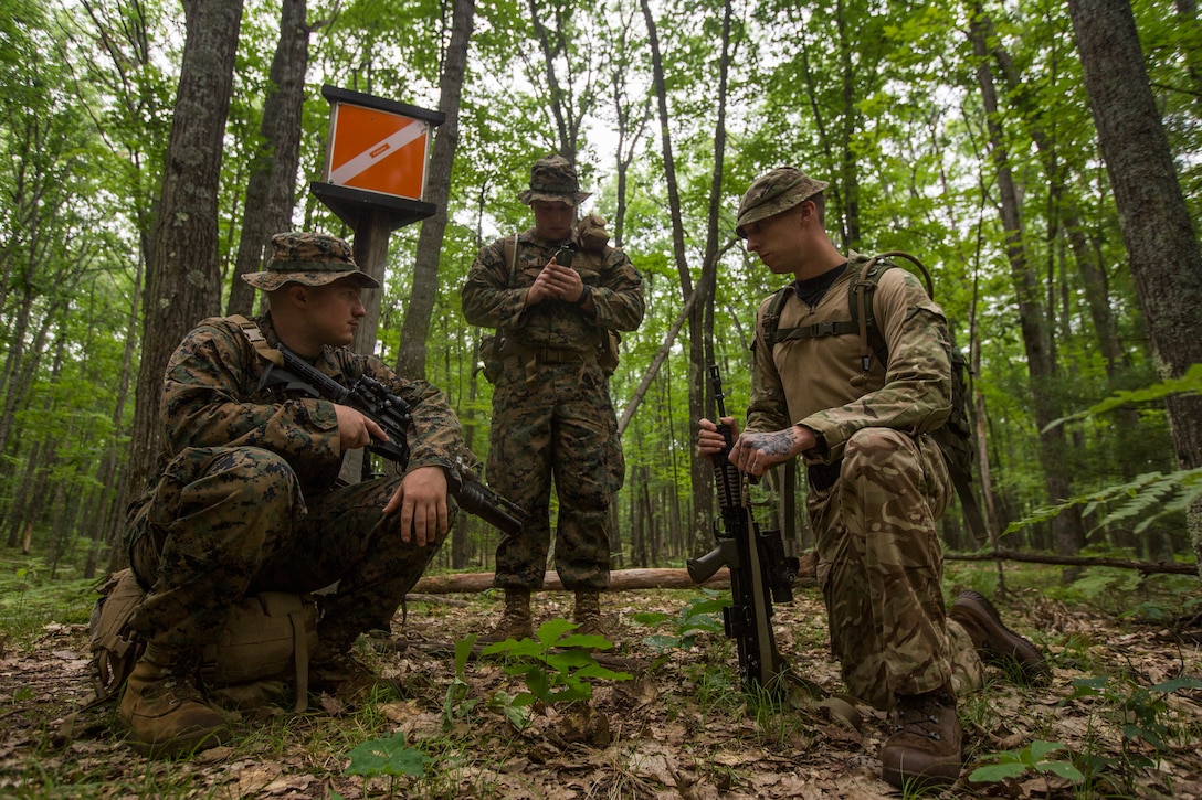 British Lance Cpl. PJ Moleod (left), a medic with 3rd Princess of Wales Royal Regiment, and U.S. Marine Corps Sgt. Jacob Mueller (center) and Sgt. Charlie Bliss (right) squad leaders with Kilo Company, 3rd Battalion, 25th Marine Regiment, participate in a land navigation course at Exercise Northern Strike in Camp Grayling, Mich., Aug. 6, 2018.