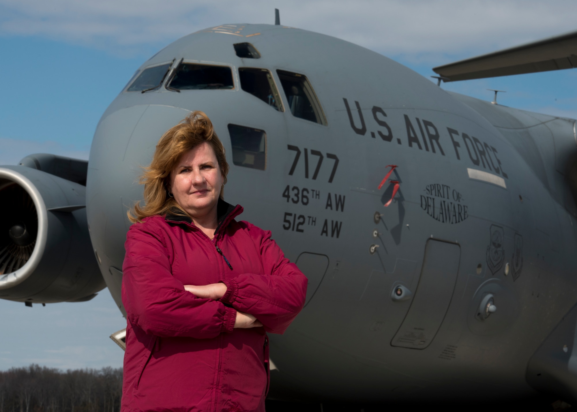 Retired Senior Master Sgt. Kathleen Lambert, a former 512th Airlift Wing loadmaster, stands in front of a C-17 Globemaster III on the flightline at Dover Air Force Base, Del., March 6, 2018. Lambert amassed more than 3,100 flight hours as a C-17 flyer and became an evaluator and instructor loadmaster during her 33-year reserve career. (U.S Air Force photo by Senior Airman Zachary Cacicia)