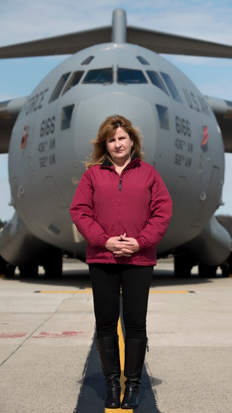Retired Senior Master Sgt. Kathleen Lambert, a former 512th Airlift Wing loadmaster, stands in front of a C-17 Globemaster III on the flightline at Dover Air Force Base, Del., March 6, 2018. Lambert was one of the initial aircrew members to be fully trained and qualified on C-17s when they first arrived to Dover AFB in 2007. (U.S Air Force photo by Senior Airman Zachary Cacicia)