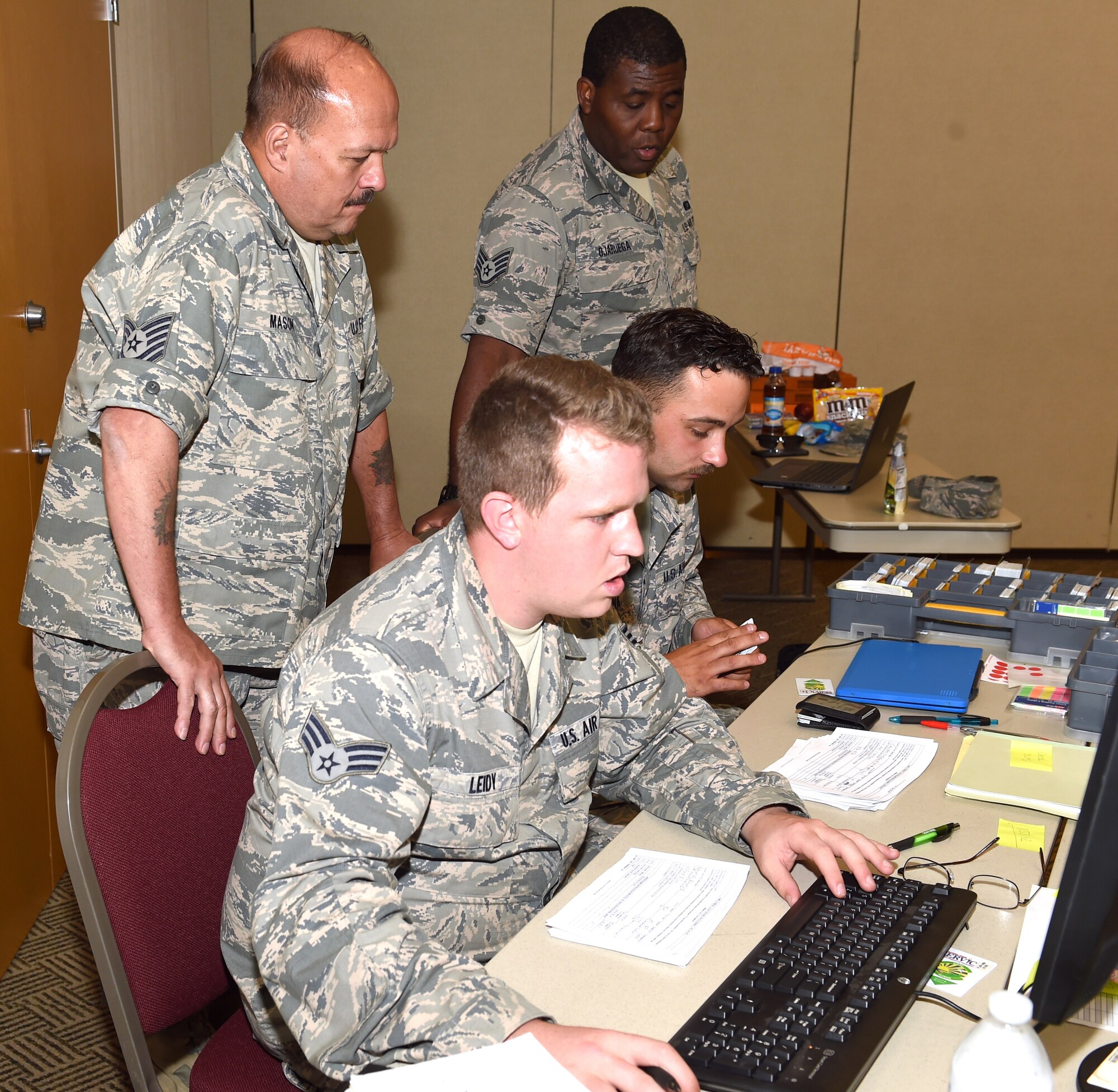 Tech. Sgt. Ben Mason, Staff Sgt. Emuobosan Ojaruega, Senior Airman Joshua Leidy and Airman 1st Class Angelo Raona, all lodging team members from the 127th Force Support Squadron, Selfridge Air National Guard Base, Mich., assist in managing lodging assignments during Exercise Northern Strike 18 at Alpena Combat Readiness Training Center on August 4, 2018.