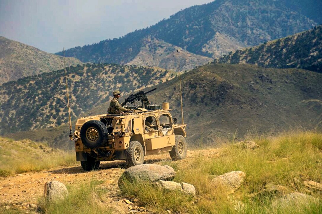 A solider sits in vehicle.