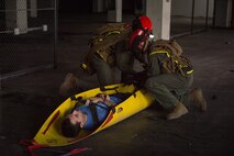 Extract Marines with Chemical Biological Incident Response Force pull a survivor out of a simulated collapsed building during Exercise Chicago Response in Champaign, Illinois, July 25, 2018. This was the first time the active duty response force trained with Chicago-area first responders and served to establish a working relationship between CBIRF and the city of Champaign and Chicago.