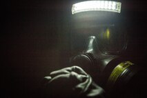 An extract Marine with Chemical Biological Incident Response Force searches for survivors in the dark in a simulated collapsed building during Exercise Chicago Response in Champaign, Illinois July 25, 2018. This was the first time the active duty response force trained with Chicago-area first responders and served to establish a working relationship between CBIRF and the city of Champaign and Chicago.
