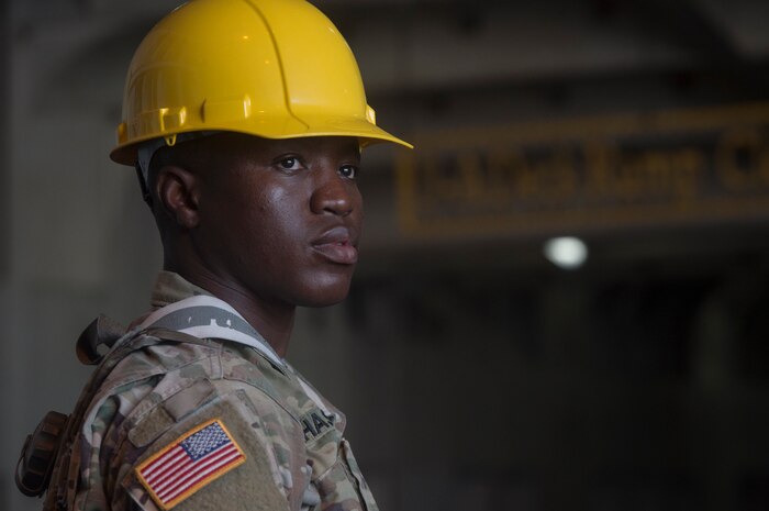 U.S. Army Spc. Aaron Alhassan, 149th Seaport Operations Company, 10th Transportation Battalion, 7th Transportation Brigade, observes vessel loading operations during Exercise Dragon Lifeline July 31, 2018, at the Federal Law Enforcement Training Center in Charleston, S.C.  The 841st Transportation Battalion hosted the exercise, facilitating training for Soldiers assigned to Fort Bragg, N.C., and Fort Eustis, Va. The exercise was designed to train participants in the planning and processes of rail, convoy, port and vessel operations.