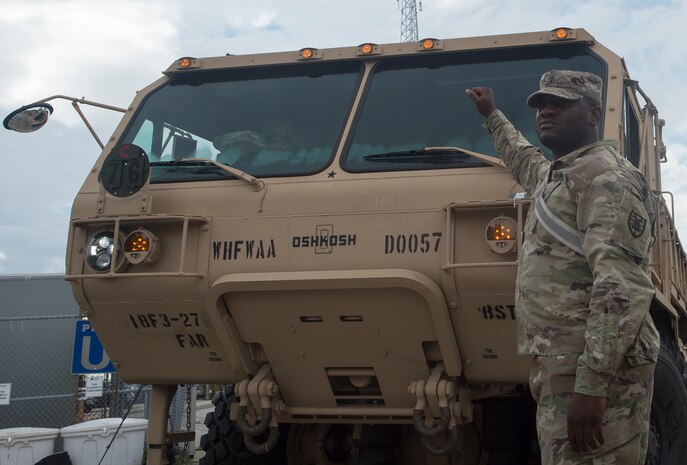 U.S. Army Jude Kpollie, 149th Seaport Operations Company, 10th Transportation Battalion, 7th Transportation Brigade, directs vehicle traffic during Exercise Dragon Lifeline July 31, 2018, at the Federal Law Enforcement Training Center in Charleston, S.C. The 841st Transportation Battalion hosted the exercise, facilitating training for Soldiers assigned to Fort Bragg, N.C., and Fort Eustis, Va. The exercise was designed to train participants in the planning and processes of rail, convoy, port and vessel operations.