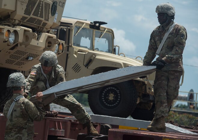 U.S. Army Soldiers prepare to transport vehicles during rail operations as part of Exercise Dragon Lifeline July 31, 2018, at Joint Base Charleston’s Naval Weapons Station, S.C. The 841st Transportation Battalion hosted the exercise, facilitating training for Soldiers assigned to Fort Bragg, N.C., and Fort Eustis, Va. The exercise was designed to train participants in the planning and processes of rail, convoy, port and vessel operations.