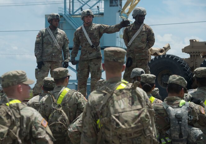 U.S. Army Sgt. Micheal Suarez, center, 359th Inland Cargo Transfer Company, 10th Transportation Battalion, 7th Sustainment Brigade, briefs Soldiers prior to conducting rail operations as part of Exercise Dragon Lifeline July 31, 2018, at Joint Base Charleston’s Naval Weapons Station, S.C. The 841st Transportation Battalion hosted the exercise, facilitating training for Soldiers assigned to Fort Bragg, N.C., and Fort Eustis, Va. The exercise was designed to train participants in the planning and processes of rail, convoy, port and vessel operations.