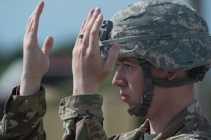 U.S. Army Private 1st Class Samuel Phalin, 8th Ordnance Company, Fort Bragg, NC, guides a vehicle driver during rail operations as part of Exercise Dragon Lifeline Aug. 1, 2018, at Joint Base Charleston’s Naval Weapons Station, S.C. The 841st Transportation Battalion hosted the exercise, facilitating training for Soldiers assigned to Fort Bragg N.C., and Fort Eustis, Va. The exercise was designed to train participants in the planning and processes of rail, convoy, port and vessel operations.