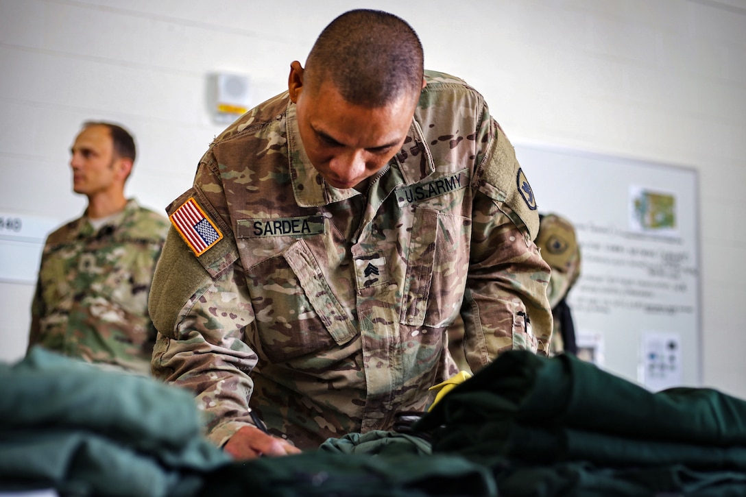 A soldier inventories new equipment his unit received.