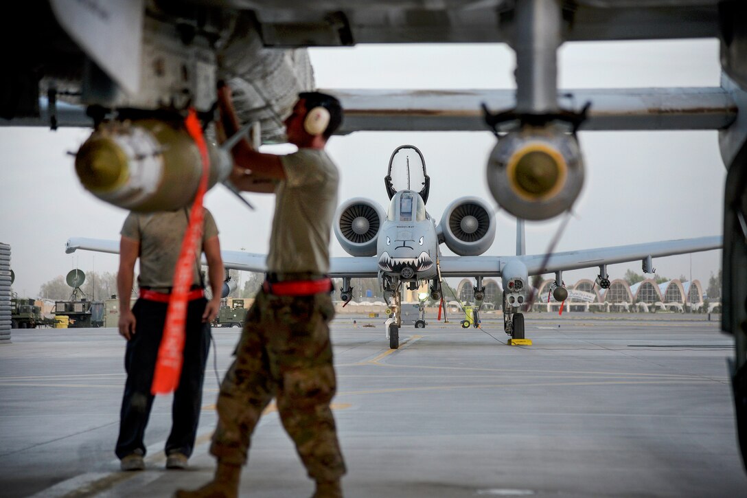 Air Force crew chiefs conduct preflight checks on an A-10C Thunderbolt II.