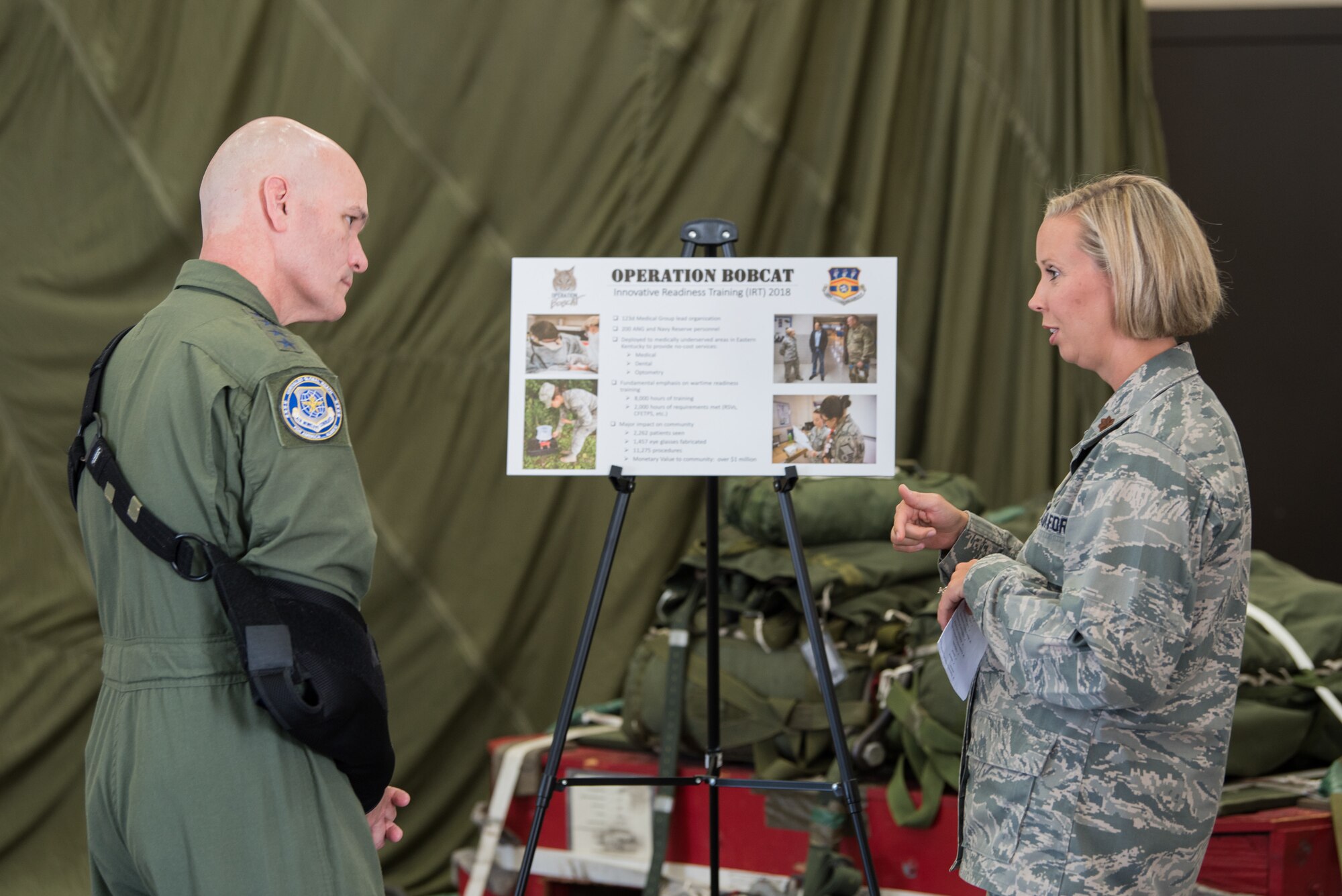 The commander of Air Mobility Command, Gen. Carlton D. Everhart II (left), speaks Maj. Alyson Harris of the 123rd Medical Group during a tour of the Kentucky Air National Guard Base in Louisville, Ky., Aug. 3, 2018. The group recently completed a field exercise that provided more than $1 million worth of no-cost health care to residents of Eastern Kentucky. (U.S. Air National Guard photo by Master Sgt. Phil Speck)