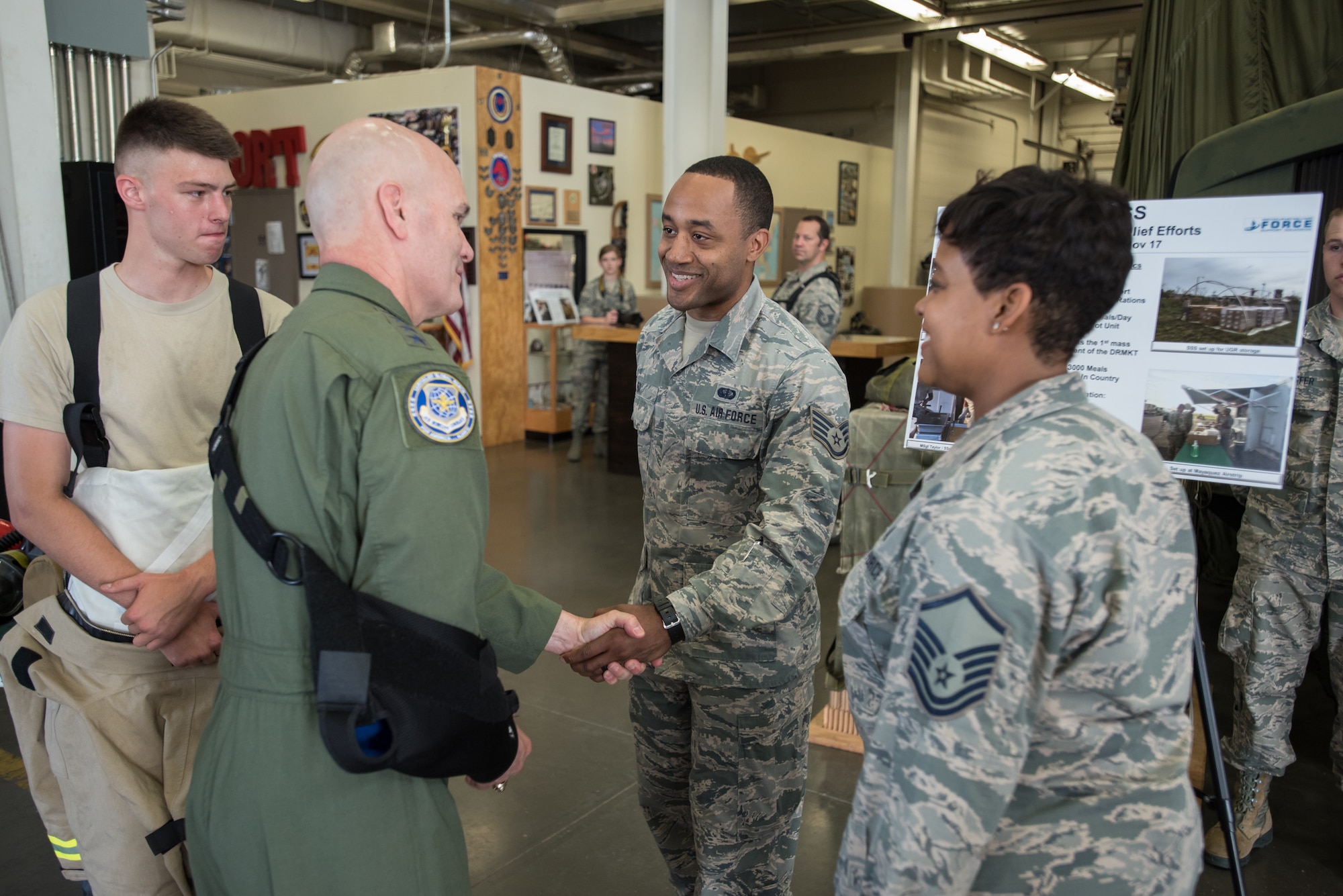 The commander of Air Mobility Command, Gen. Carlton D. Everhart II (second from left), greets Staff Sgt. Raymond Ray of the 123rd Force Support Squadron during a tour of the Kentucky Air National Guard Base in Louisville, Ky., Aug. 3, 2018. The squadron provided mobile field kitchen assets for hurricane recovery efforts in the Caribbean last year. (U.S. Air National Guard photo by Lt. Col. Dale Greer)