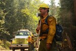 Washington Air National Guard Staff Sgt. Eric Delaune, 141st Maintenance Squadron, takes a break from fighting the Sheep Creek fire Aug. 6, 2018, near Northport, Wash. Delaune is on a hand crew that clears out burnable materials from the path of the fire to deny it fuel to spread.
