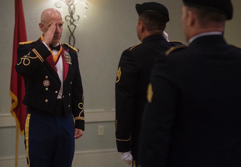 Col. Daniel Keller, 1189th Transportation Surface Battalion outgoing commander, returns a salute from a color guard detail during the 1189th TSB Mardi Gras Masquerade Ball at the Crowne Plaza Charleston Airport Hotel Aug. 4, 2018, in North Charleston, S.C. Brig. Gen. Martin Klein, Deployment Support Command commander, talked about the importance of the U.S. Army Reserve as the guest speaker for the event.