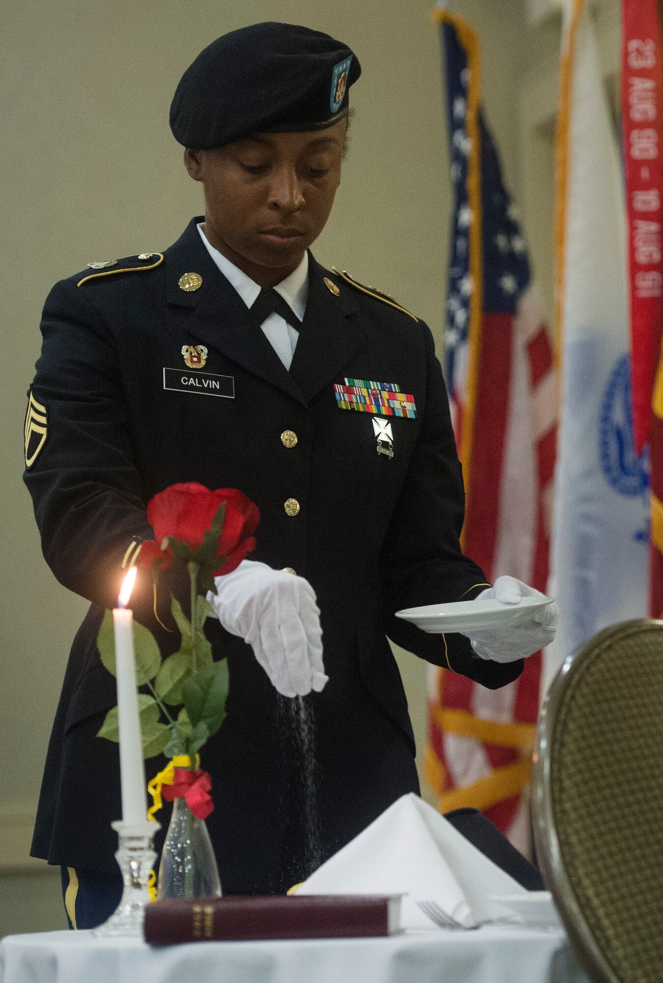 U.S. Army Staff Sgt. Erica Calvin, 1189th Transportation Surface Brigade senior LAN specialist, honors the fallen during a fallen soldier recognition ceremony as part of the 1189th TSB Mardi Gras Masquerade Ball at the Crowne Plaza Charleston Airport Hotel Aug. 4, 2018, in North Charleston, S.C. Brig. Gen. Martin Klein, Deployment Support Command commander, talked about the importance of the U.S. Army Reserve as the guest speaker for the event.