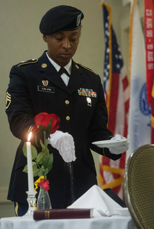 U.S. Army Staff Sgt. Erica Calvin, 1189th Transportation Surface Brigade senior LAN specialist, honors the fallen during a fallen soldier recognition ceremony as part of the 1189th TSB Mardi Gras Masquerade Ball at the Crowne Plaza Charleston Airport Hotel Aug. 4, 2018, in North Charleston, S.C. Brig. Gen. Martin Klein, Deployment Support Command commander, talked about the importance of the U.S. Army Reserve as the guest speaker for the event.