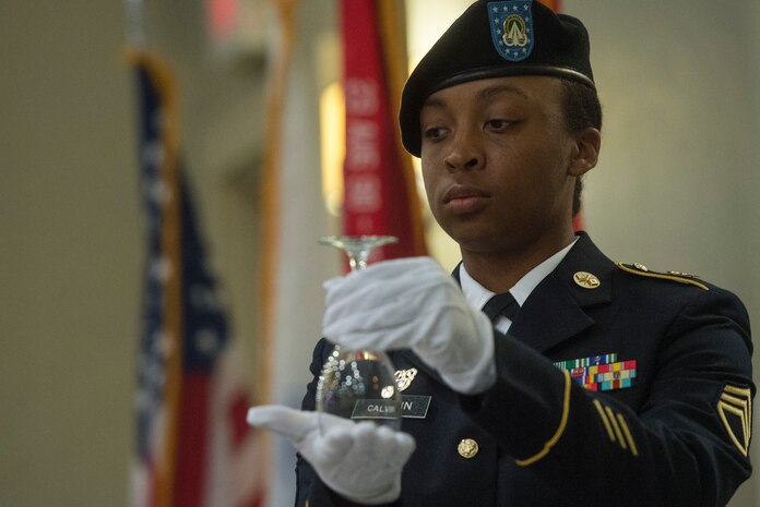 U.S. Army Staff Sgt. Erica Calvin, 1189th Transportation Surface Brigade senior local area network specialist, honors the fallen during a fallen soldier recognition ceremony as part of the 1189th TSB Mardi Gras Masquerade Ball at the Crowne Plaza Charleston Airport Hotel Aug. 4, 2018, in North Charleston, S.C. Brig. Gen. Martin Klein, Deployment Support Command commander, talked about the importance of the U.S. Army Reserve as the guest speaker for the event.