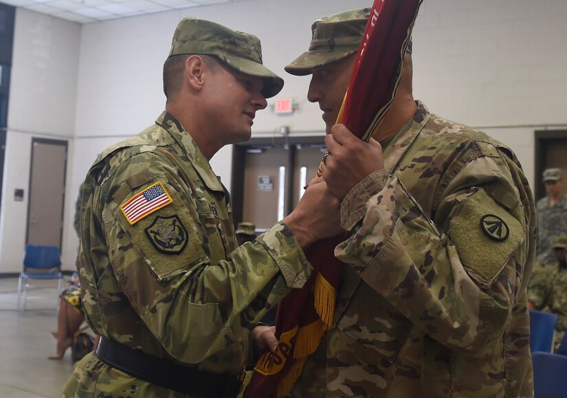 Brig. Gen. Martin F. Klein, Deployment Support Command commander, passes the command guidon to Col. Mark. R. McCullough, 1189th Transportation Surface Brigade’s incoming commander, during a change of command ceremony Aug. 5, 2018, at the Thomas H. Martin Reserve Center at Joint Base Charleston - Weapons Station, S.C. McCullough assumed command from Col. Daniel A. Keller, 1189th TSB outgoing commander.