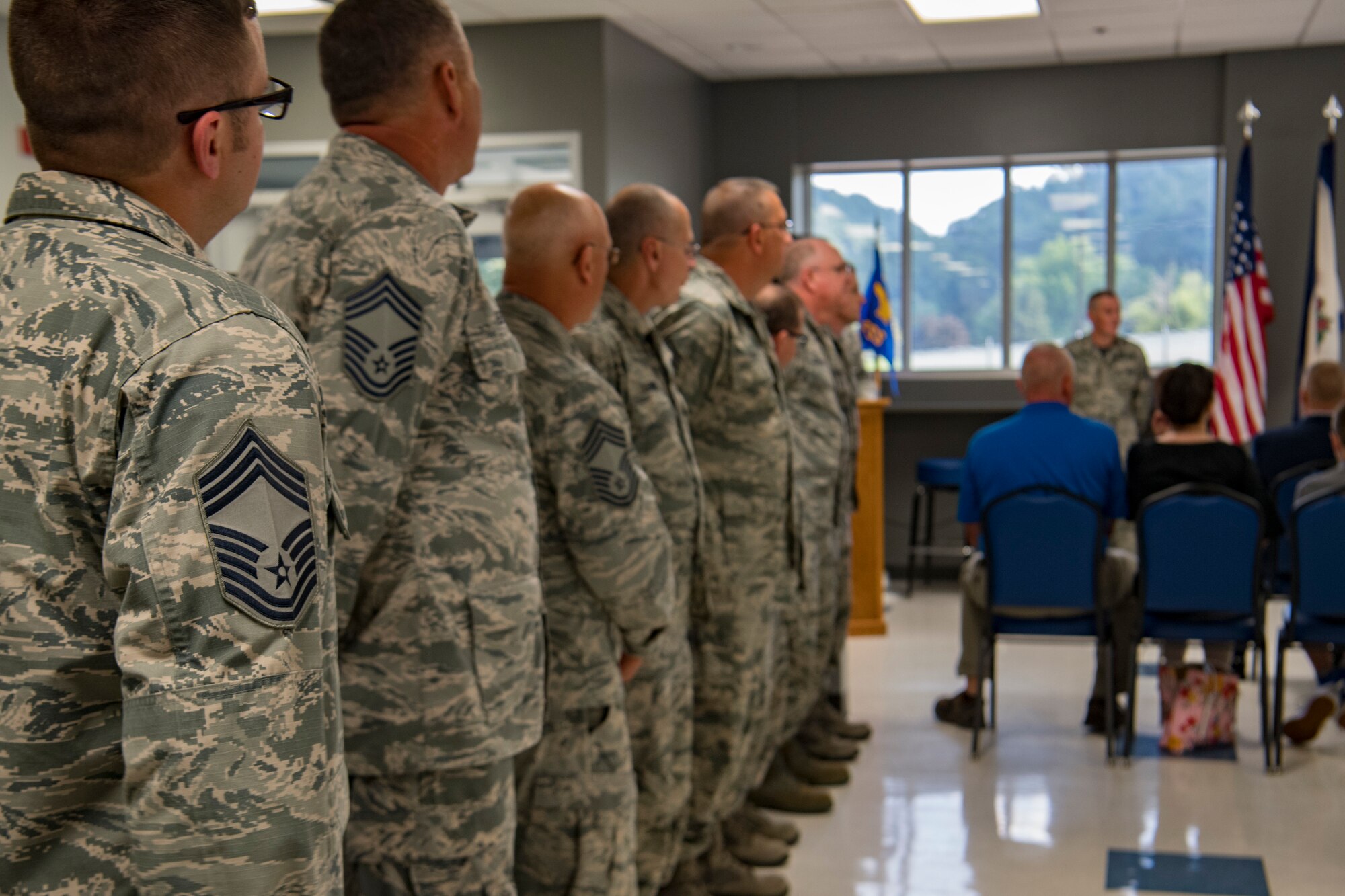 Chief Master Sgt. Jason Evans, 130th Force Support Squadron Chief, gets his new stripes tacked on by his wife and daughter Aug. 4, 2018 at McLaughlin Air National Guard Base, Charleston, W.Va.(U.S. Air National Guard Photo by Airman 1st Class Caleb Vance)