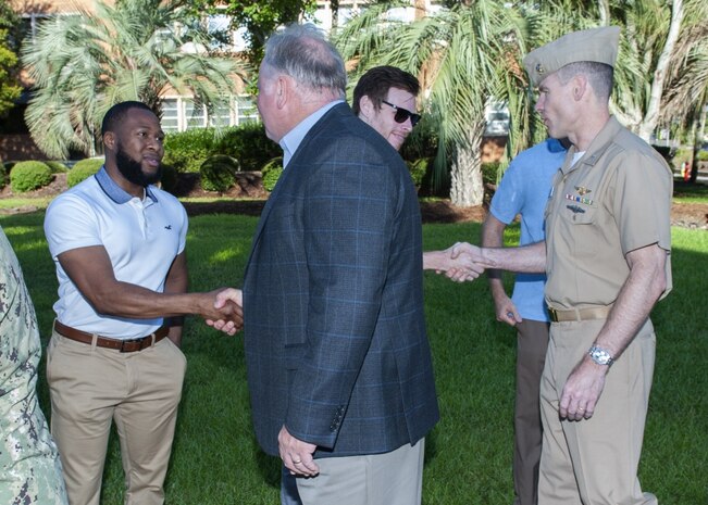 PANAMA CITY, Florida - Naval Surface Warfare Center Panama City Division (NSWC PCD) Technical Director Ed Stewart (SES) (left) and Executive Officer Cmdr. Kevin Christenson, USN, (right), welcomes NSWC PCD's newly hired federal civil service employees at the flagpole Aug. 6, 2018. U.S. Navy photos by Eddie Green