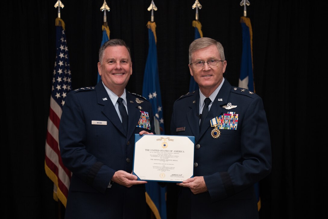 Lt. Gen. Marshall B. Webb (left), commander of the Air Force Special Operations Command (AFSOC), Hurlbert Field, Florida, presents the Distinguished Service Medal certificate to Maj. Gen. Gregory L. Ferguson, Air National Guard assistant to the commander, AFSOC, during Ferguson's retirement ceremony at Will Rogers Air National Guard Base in Oklahoma City, Aug. 4, 2018.
