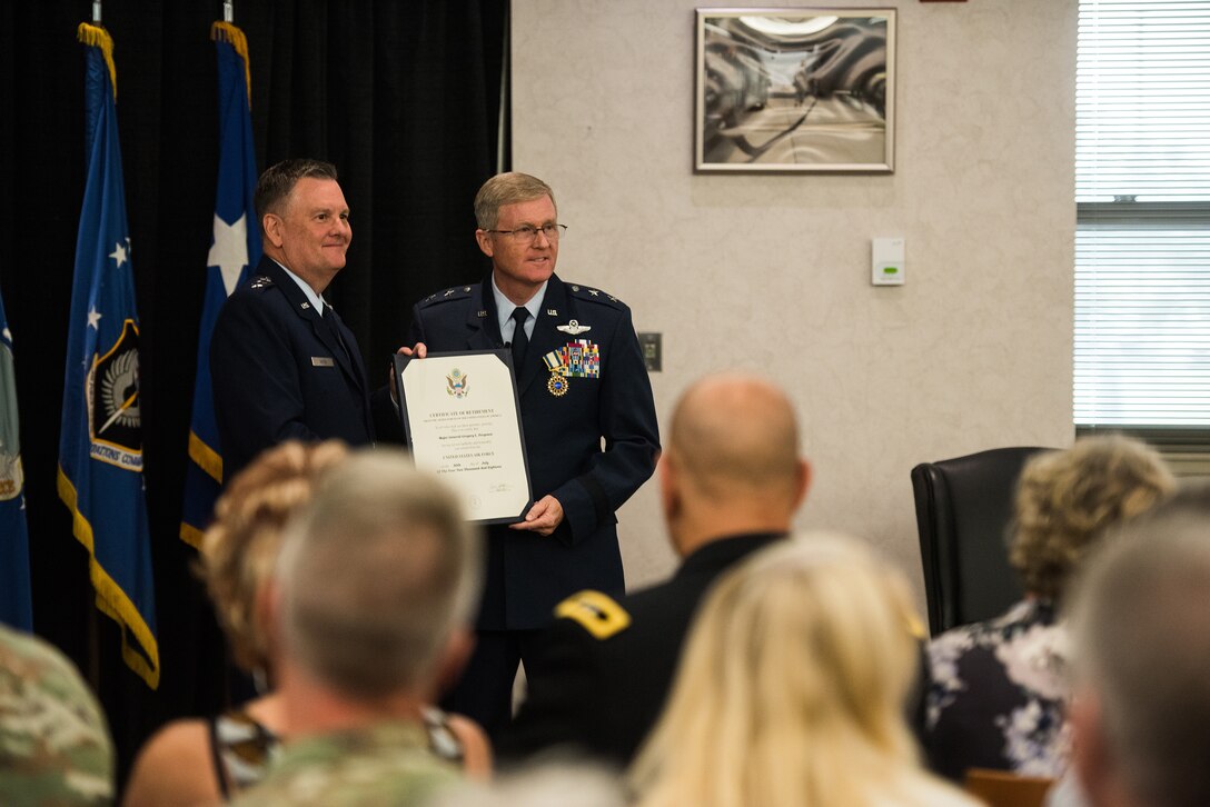 Lt. Gen. Marshall B. Webb (left), commander of the Air Force Special Operations Command (AFSOC), Hurlbert Field, Florida, presents a certificate of retirement to Maj. Gen. Gregory L. Ferguson, Air National Guard assistant to the commander, AFSOC, during Ferguson's retirement ceremony at Will Rogers Air National Guard Base in Oklahoma City, Aug. 4, 2018.
