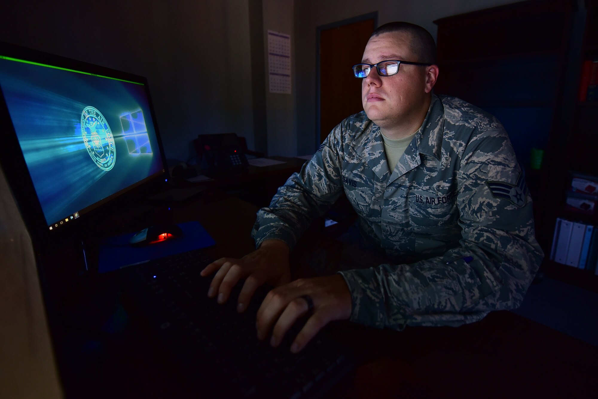 Man sits at desk and types on keyboard.