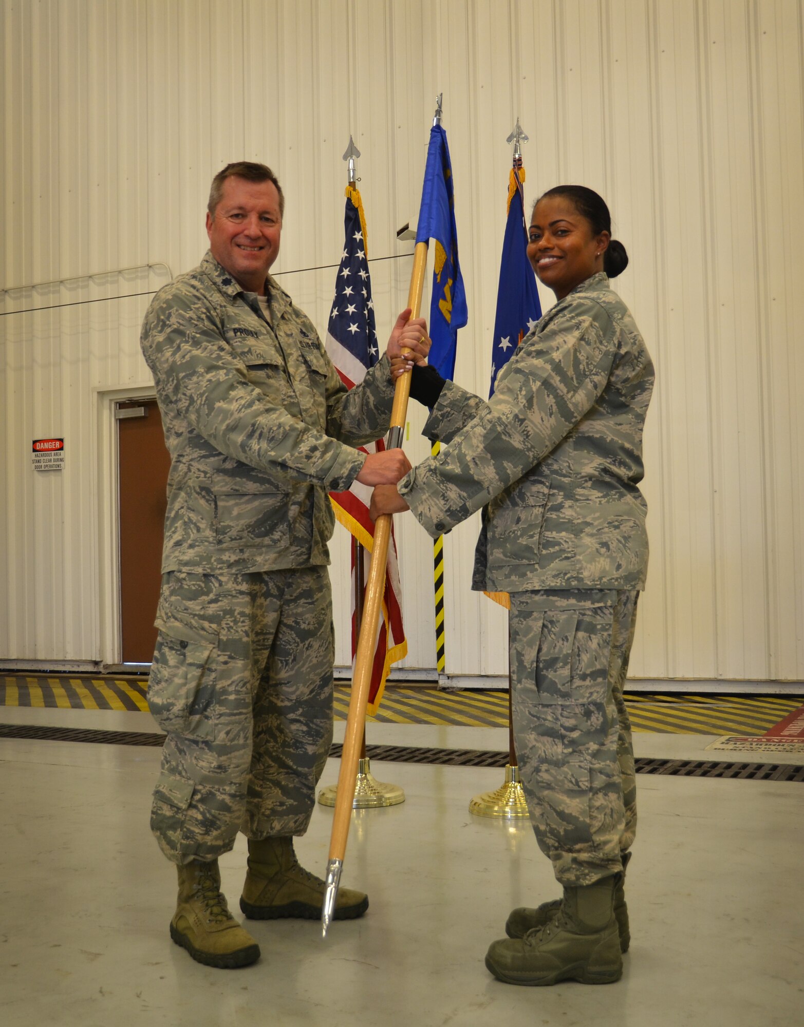Maj. Katrina Jones assumes command of the 94th Maintenance Squadron during a change of command ceremony on August 5, 2018 at Dobbins Air Reserve Base. The 94th MXS guide on flag is exchanged from group commander to new unit commander to symbolize the assumption of leadership.  (U.S. Air Force photo by Senior Airman Lauren Douglas)