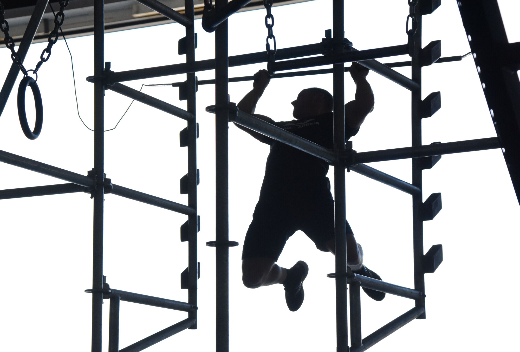 Kevin Klein, Alpha Warrior professional athlete, provides an obstacle demonstration inside Hangar Four on Keesler Air Force Base, Mississippi, Aug. 2, 2018. During the Alpha Warriors' two-day visit a competition was held for Airmen competing on the Alpha Warrior battle rig. (U.S. Air Force photo by Kemberly Groue)