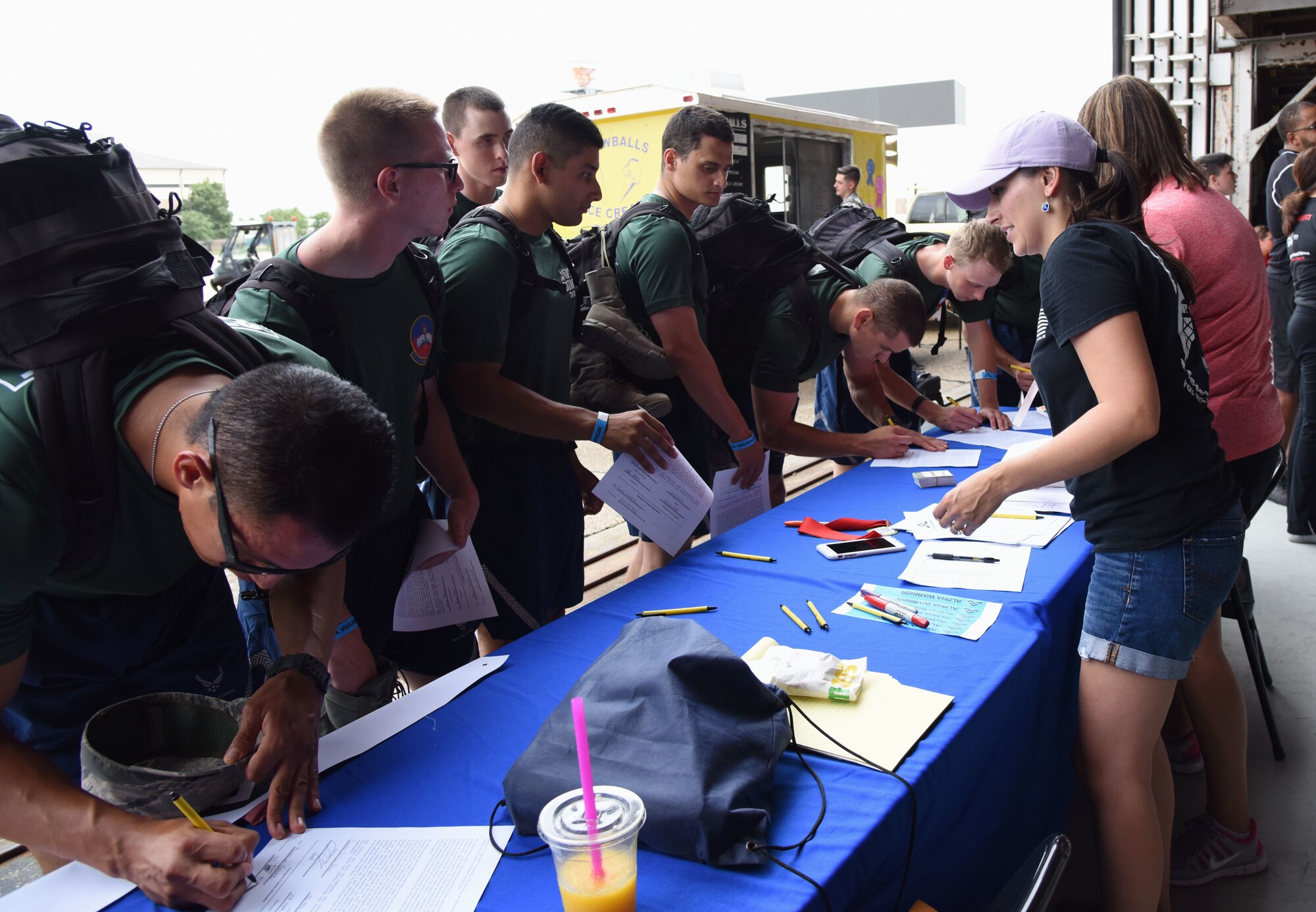 Airmen from the 81st Training Group check in for the Alpha Warrior battle rig competition inside Hangar Four on Keesler Air Force Base, Mississippi, Aug. 3, 2018. More than 100 Keesler Airmen participated in the competition hosted by the 81st Force Support Squadron and the Air Force Services Activity. (U.S. Air Force photo by Kemberly Groue)