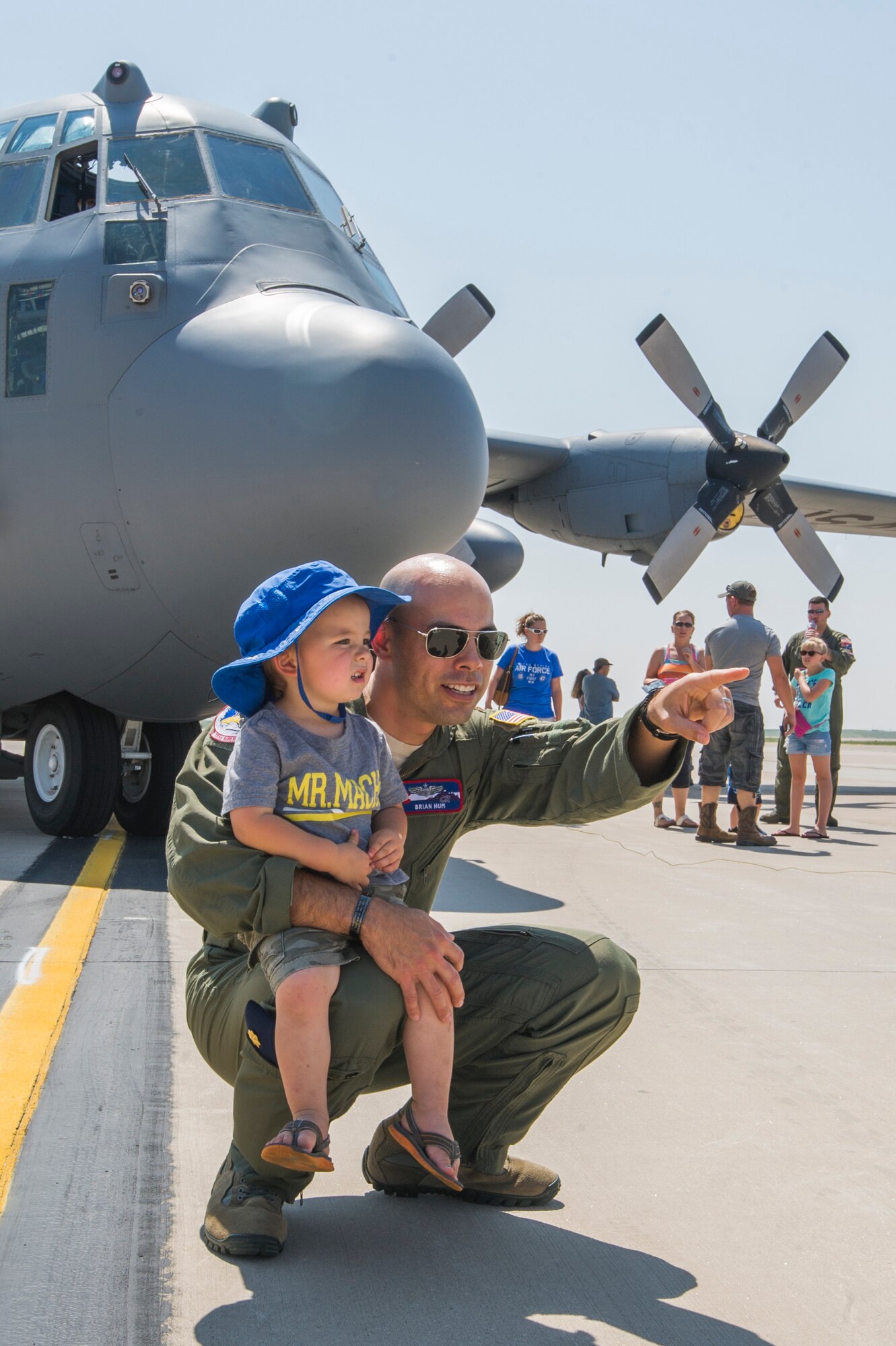 Maj. Brian Hum, a 731st Airlift Squadron reservist, watches aircraft takeoff with his son, Isaac, on the flight line at Peterson Air Force Base, Colorado, during the 302nd Airlift Wing’s Family Day, Aug. 4, 2018. (U.S. Air Force photo by Staff Sgt. Amber Sorsek)
