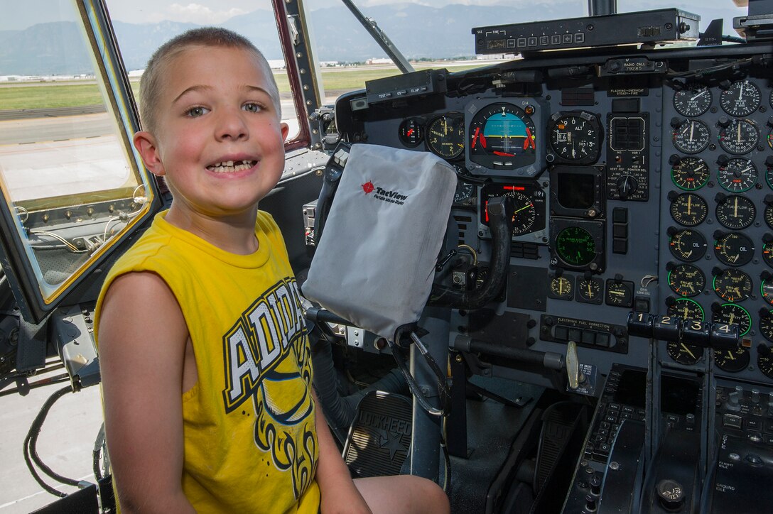 Noah Harder, son of Chaplain (Maj.) Todd Harder, 302nd Airlift Wing, sits in the flight deck of a C-130 Hercules aircraft during the 302nd AW’s Family Day, Aug. 4, 2018, at Peterson Air Force Base, Colorado.  (U.S. Air Force photo by Staff Sgt. Amber Sorsek)