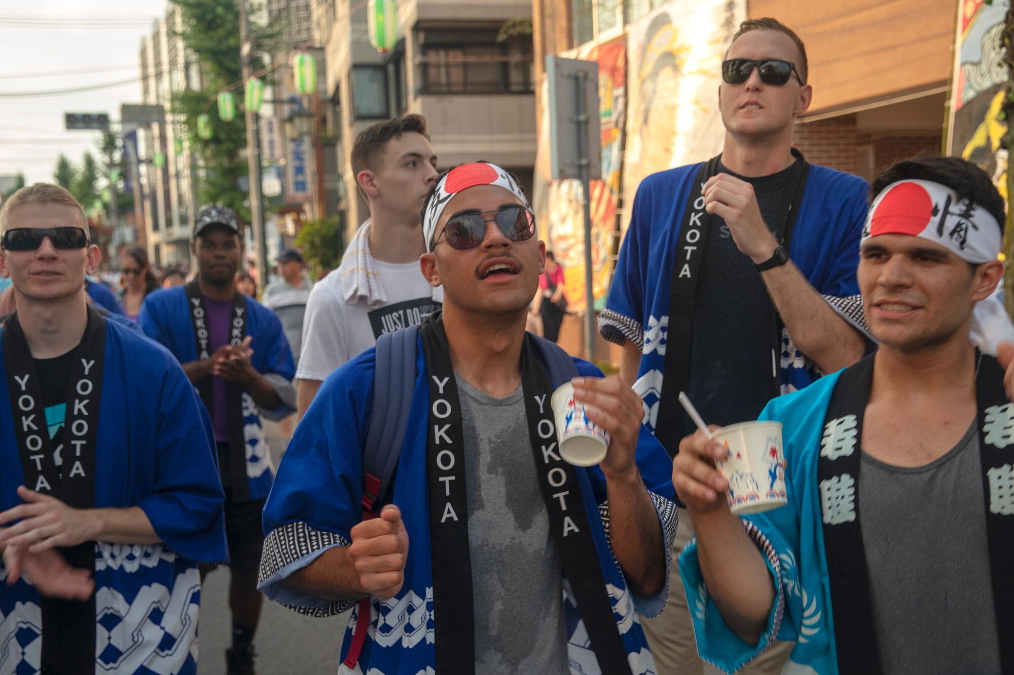 Members from Yokota Air Base cheer after carrying the 374th Airlift Wing's official mikoshi