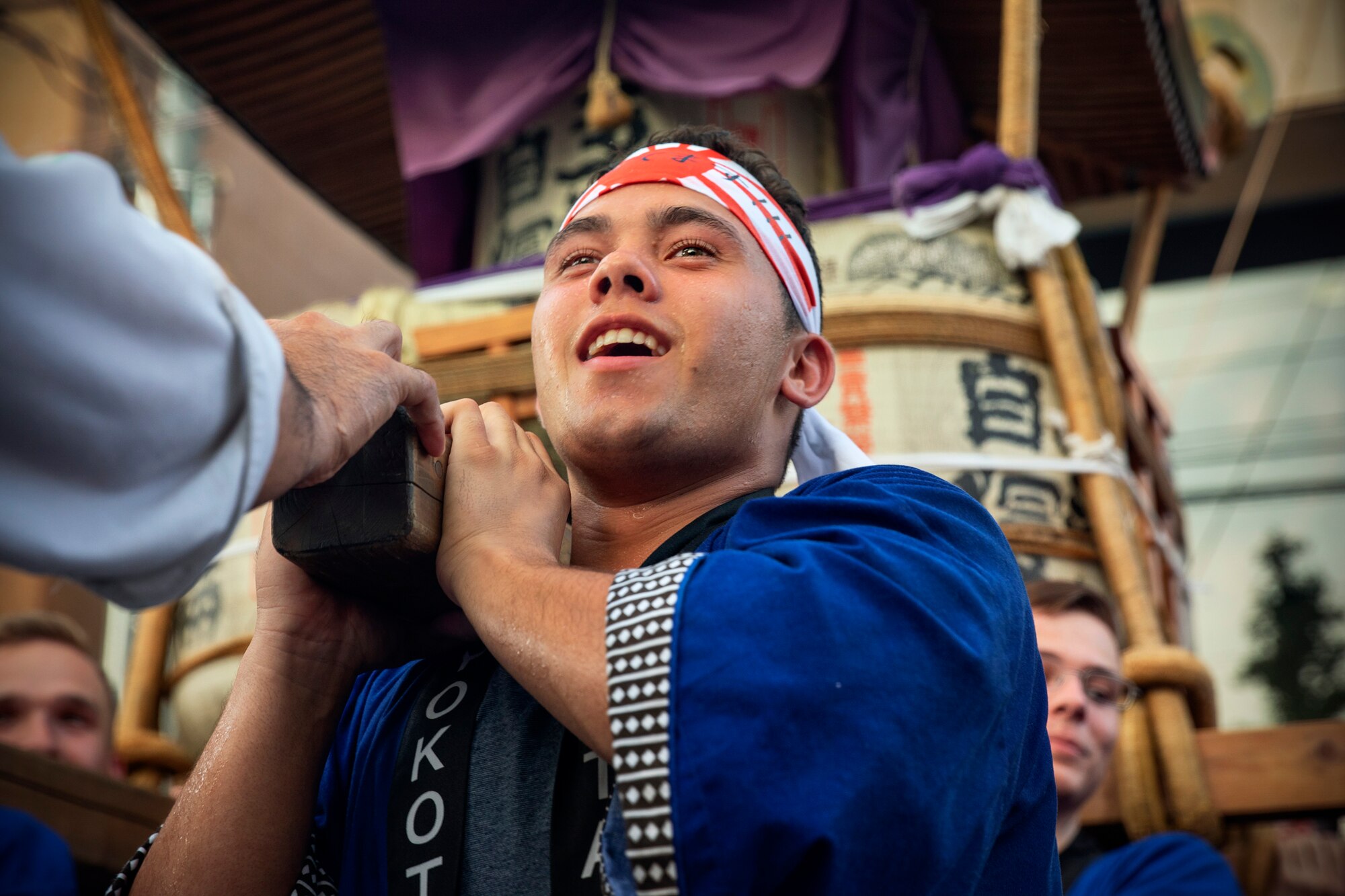 An Airman from Yokota Air Base carries the 374th Airlift Wing's official mikoshi during the 68th Annual Fussa Tanabata Festival